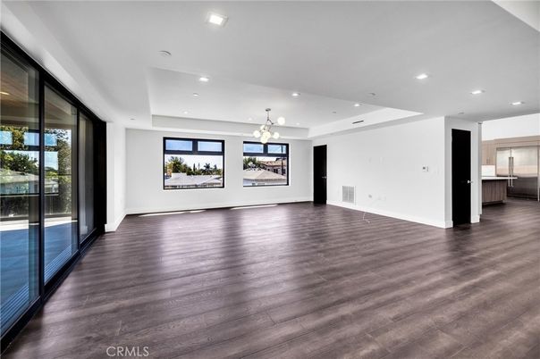 Empty room, Interior, Kitchen, Pendant Lights, Recessed Lighting, Stainless Steel Appliances, Wood Texture Flooring