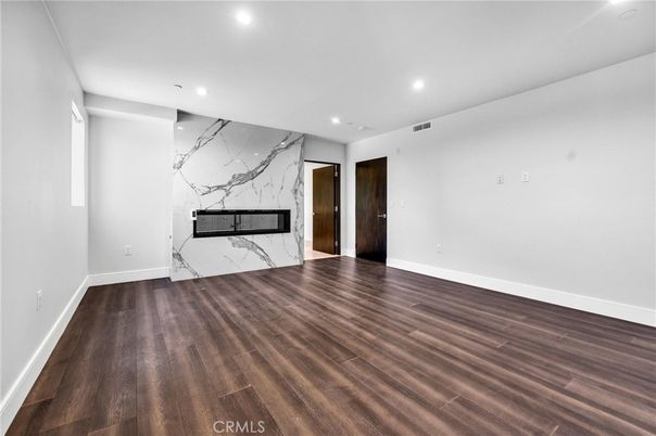 Empty room, Fireplace, Interior, Marble Walls, Recessed Lighting, Wood Texture Flooring