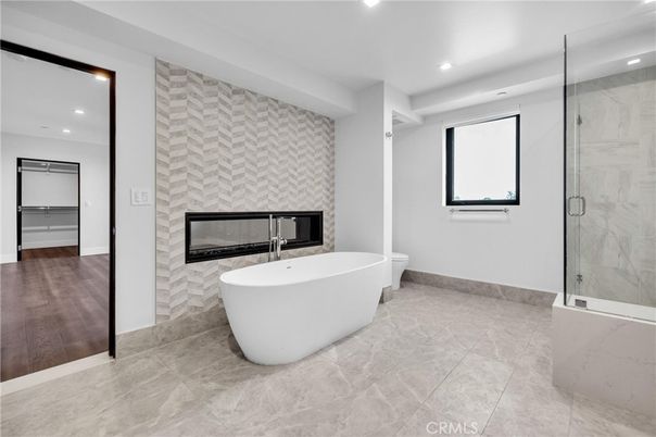 Bathroom, Free Standing Baths, Glass Shower, Interior, Marble Walls, Recessed Lighting, Wood Texture Flooring