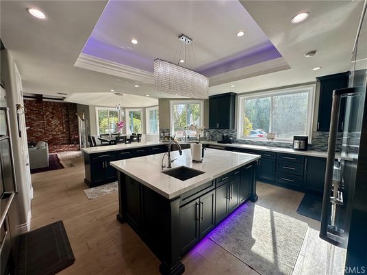 Chandelier, Interior, Kitchen, Pendant Lights, Recessed Lighting, Stainless Steel Appliances, Stone Walls, Wood Texture Flooring
