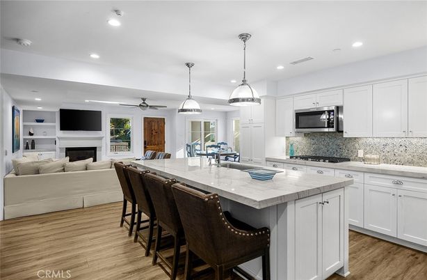Dining room, Fireplace, Interior, Kitchen, Living room, Pendant Lights, Recessed Lighting, Stainless Steel Appliances, Wood Texture Flooring