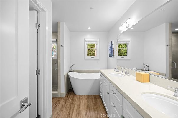 Bathroom, Dual Sink Vanities, Free Standing Baths, Glass Shower, Interior, Recessed Lighting, Wood Texture Flooring
