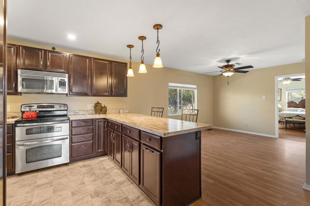 Dining room, Interior, Kitchen, Pendant Lights, Recessed Lighting, Stainless Steel Appliances, Wood Texture Flooring