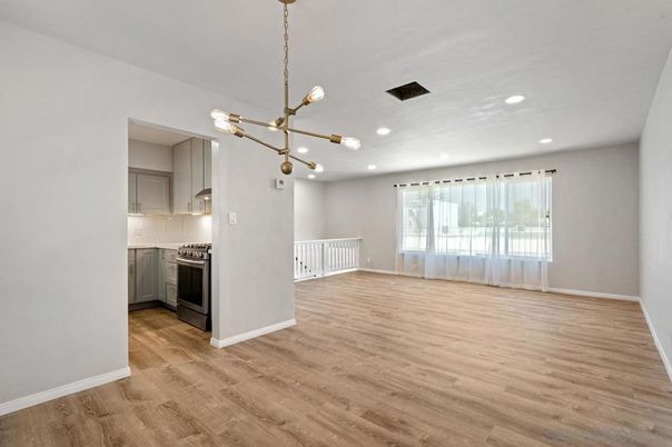 Empty room, Interior, Kitchen, Pendant Lights, Recessed Lighting, Stainless Steel Appliances, Wood Texture Flooring