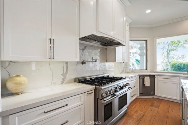 Interior, Kitchen, Marble Walls, Recessed Lighting, Stainless Steel Appliances, Wood Texture Flooring