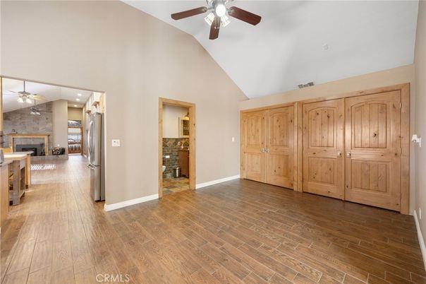 Empty room, Fireplace, Interior, Kitchen, Recessed Lighting, Stone Walls, Wood Texture Flooring