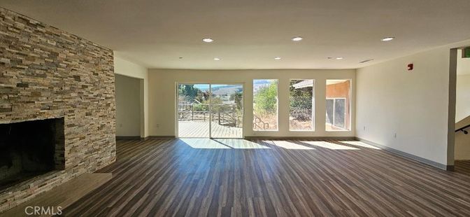Empty room, Fireplace, Interior, Recessed Lighting, Stone Walls, Wood Texture Flooring