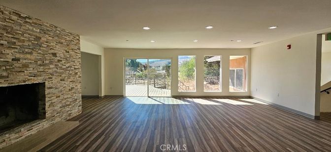 Empty room, Fireplace, Interior, Recessed Lighting, Stone Walls, Wood Texture Flooring
