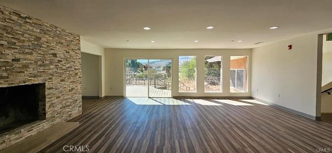 Empty room, Fireplace, Interior, Recessed Lighting, Stone Walls, Wood Texture Flooring