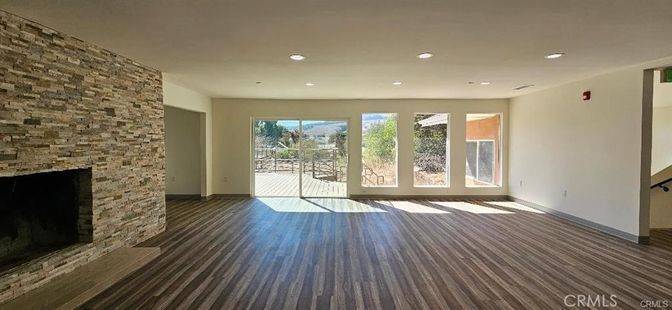 Empty room, Fireplace, Interior, Recessed Lighting, Stone Walls, Wood Texture Flooring
