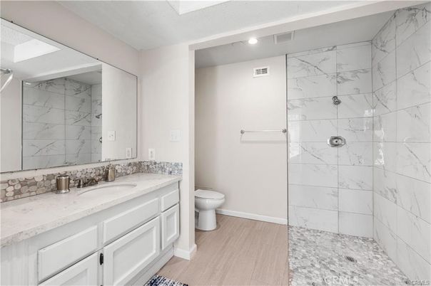Bathroom, Glass Shower, Interior, Marble Walls, Recessed Lighting, Wood Texture Flooring