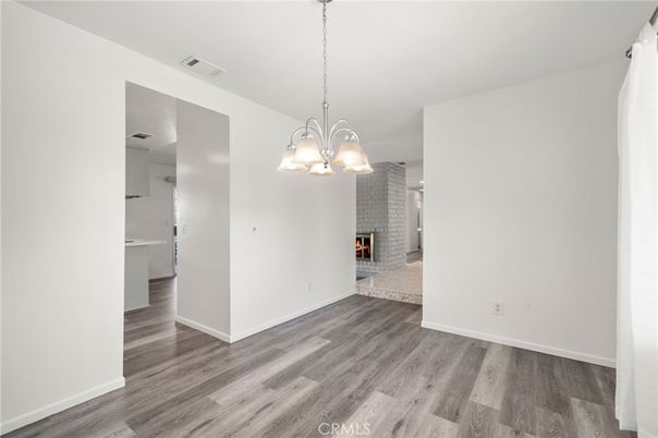 Chandelier, Empty room, Fireplace, Interior, Pendant Lights, Stone Walls, Wood Texture Flooring