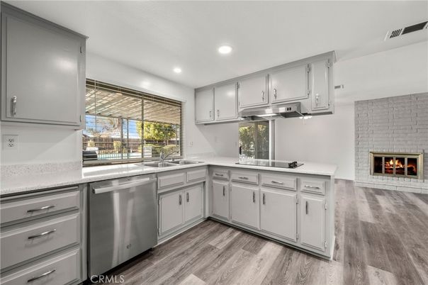 Fireplace, Interior, Kitchen, Recessed Lighting, Stainless Steel Appliances, Stone Walls, Wood Texture Flooring