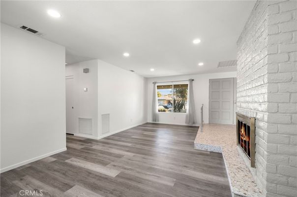Empty room, Fireplace, Interior, Recessed Lighting, Stone Walls, Wood Texture Flooring