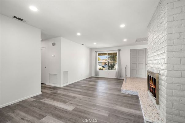 Empty room, Fireplace, Interior, Recessed Lighting, Stone Walls, Wood Texture Flooring