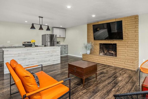 Fireplace, Interior, Kitchen, Pendant Lights, Recessed Lighting, Stainless Steel Appliances, Stone Walls, Wood Texture Flooring