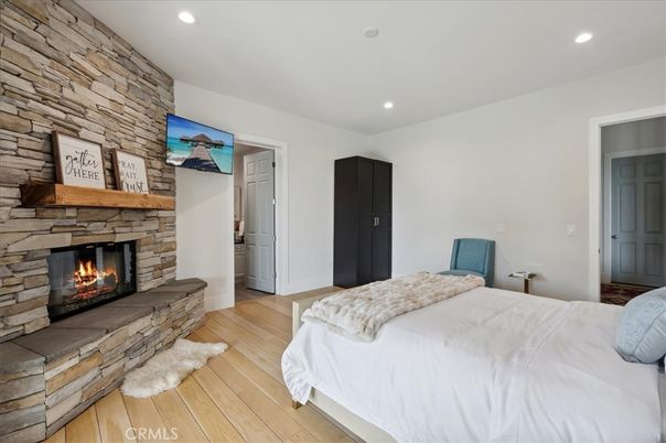 Bedroom, Fireplace, Interior, Recessed Lighting, Stone Walls, Wood Texture Flooring