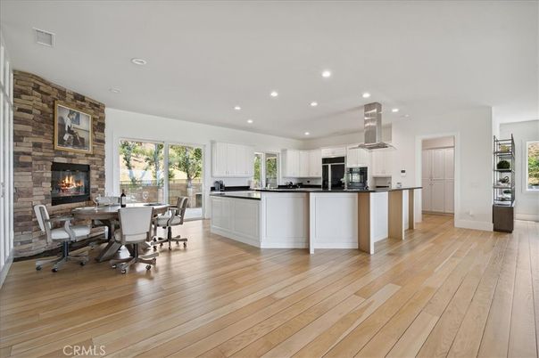 Dining room, Fireplace, Interior, Kitchen, Recessed Lighting, Stainless Steel Appliances, Stone Walls, Wood Texture Flooring