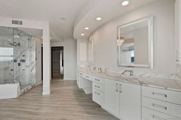 Bathroom, Dual Sink Vanities, Glass Shower, Interior, Marble Walls, Recessed Lighting, Wood Texture Flooring