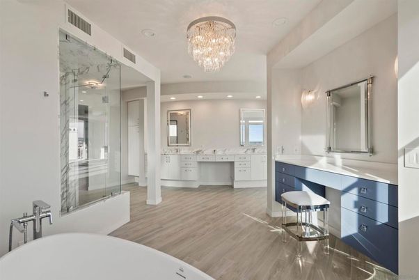 Bathroom, Chandelier, Dual Sink Vanities, Free Standing Baths, Glass Shower, Interior, Marble Walls, Recessed Lighting, Wood Texture Flooring