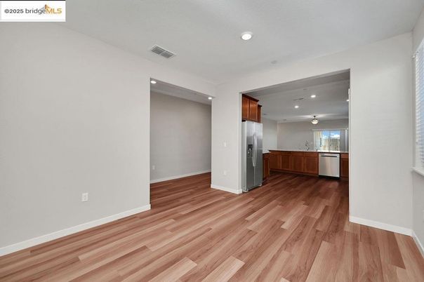 Empty room, Interior, Kitchen, Recessed Lighting, Stainless Steel Appliances, Wood Texture Flooring