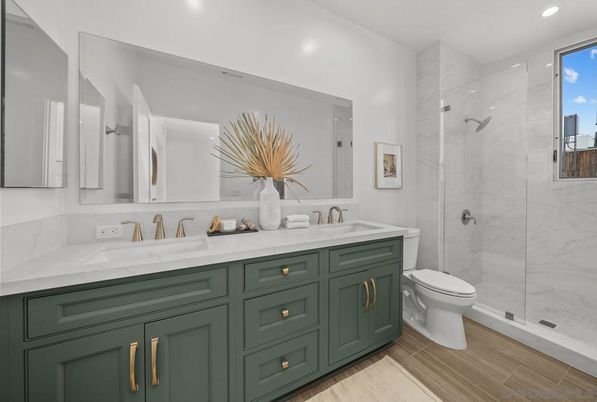 Bathroom, Dual Sink Vanities, Glass Shower, Interior, Marble Walls, Recessed Lighting, Wood Texture Flooring