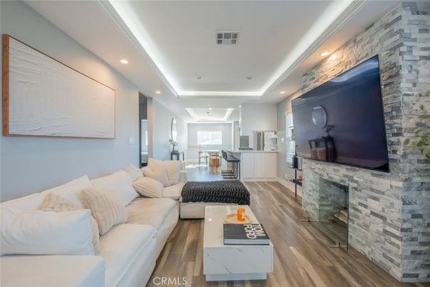 Fireplace, Interior, Living room, Recessed Lighting, Stone Walls, Wood Texture Flooring