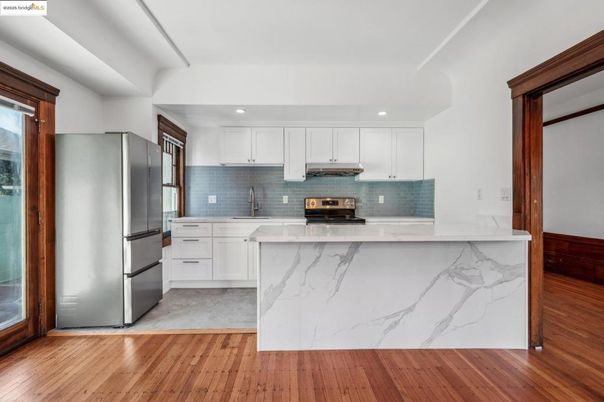 Interior, Kitchen, Marble Walls, Recessed Lighting, Stainless Steel Appliances, Wood Texture Flooring