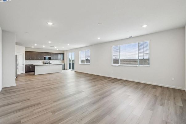 Empty room, Interior, Kitchen, Recessed Lighting, Stainless Steel Appliances, Wood Texture Flooring