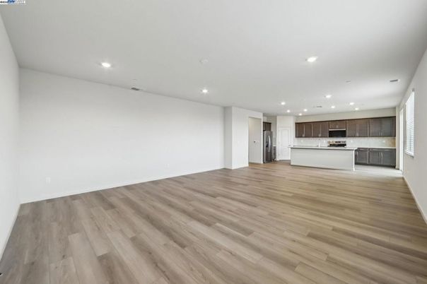 Empty room, Interior, Kitchen, Recessed Lighting, Stainless Steel Appliances, Wood Texture Flooring