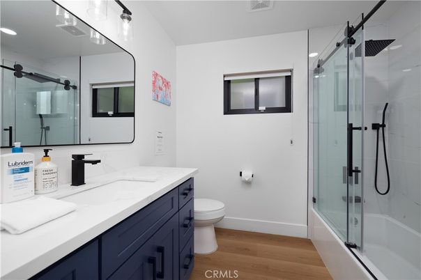 Bathroom, Dual Sink Vanities, Glass Shower, Interior, Recessed Lighting, Wood Texture Flooring