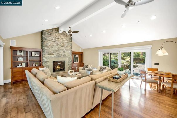 Dining room, Fireplace, Interior, Living room, Recessed Lighting, Stone Walls, Wood Texture Flooring