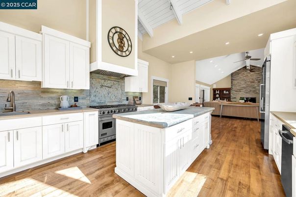 Fireplace, Interior, Kitchen, Recessed Lighting, Stainless Steel Appliances, Stone Walls, Wood Texture Flooring