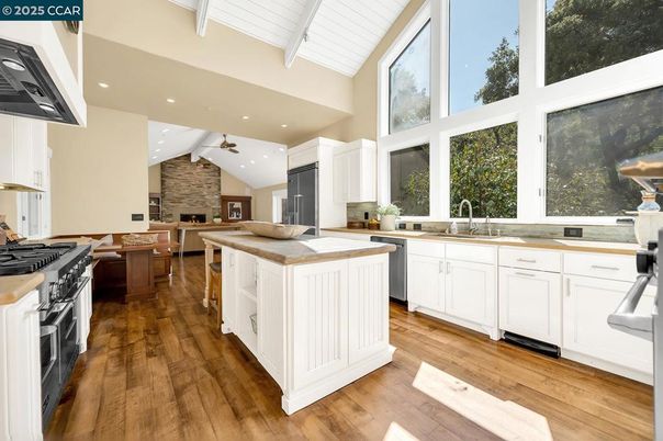 Dining room, Fireplace, Interior, Kitchen, Recessed Lighting, Stainless Steel Appliances, Stone Walls, Wood Texture Flooring