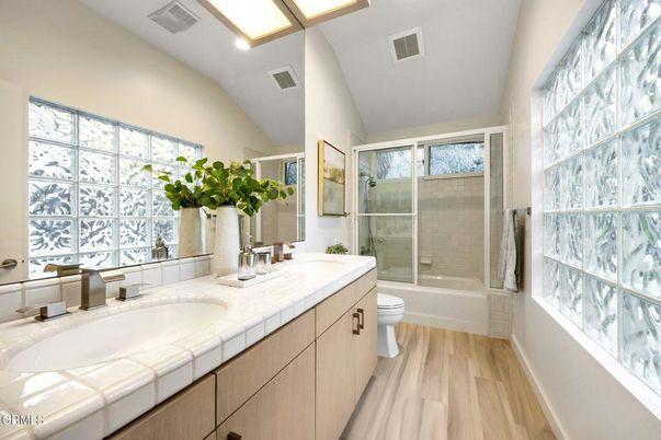 Bathroom, Dual Sink Vanities, Glass Shower, Interior, Recessed Lighting, Tile Countertops, Wood Texture Flooring