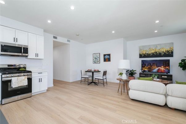 Dining room, Interior, Kitchen, Living room, Recessed Lighting, Stainless Steel Appliances, Wood Texture Flooring