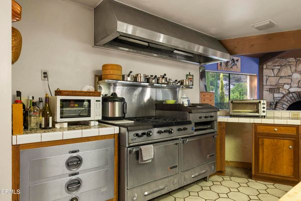 Interior, Kitchen, Stainless Steel Appliances, Stone Walls, Tile Countertops