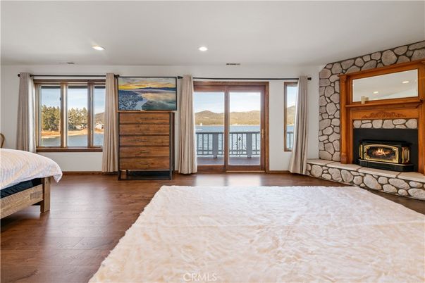 Bedroom, Fireplace, Interior, Recessed Lighting, Water, Wood Texture Flooring