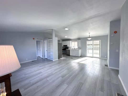 Empty room, Interior, Kitchen, Pendant Lights, Stainless Steel Appliances, Wood Texture Flooring