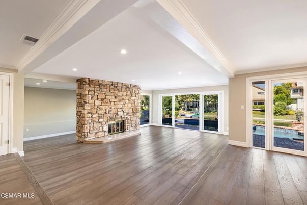 Empty room, Fireplace, Interior, Recessed Lighting, Stone Walls, Wood Texture Flooring