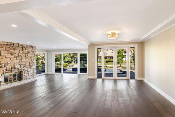 Empty room, Fireplace, Interior, Recessed Lighting, Stone Walls, Wood Texture Flooring