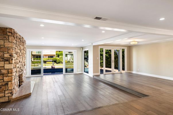 Empty room, Fireplace, Interior, Recessed Lighting, Stone Walls, Wood Texture Flooring