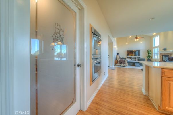 Fireplace, Interior, Kitchen, Living room, Pendant Lights, Stainless Steel Appliances, Wood Texture Flooring