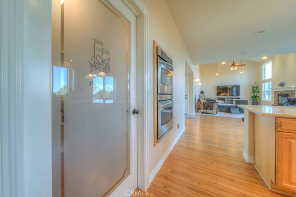 Fireplace, Interior, Kitchen, Living room, Pendant Lights, Stainless Steel Appliances, Wood Texture Flooring