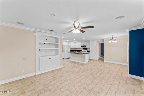 Empty room, Interior, Kitchen, Pendant Lights, Recessed Lighting, Stainless Steel Appliances, Wood Texture Flooring