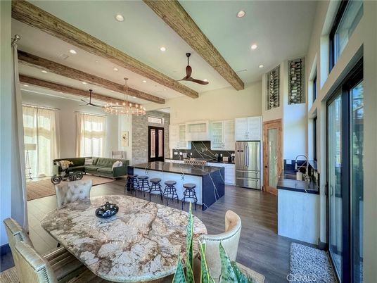 Chandelier, Dining room, Interior, Kitchen, Living room, Pendant Lights, Recessed Lighting, Stainless Steel Appliances, Wooden Beams, Wood Texture Flooring