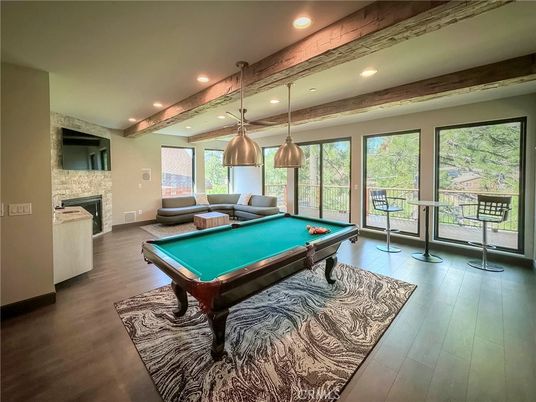 Billiard Table, Fireplace, Game Room, Interior, Pendant Lights, Recessed Lighting, Stone Walls, Wood Texture Flooring