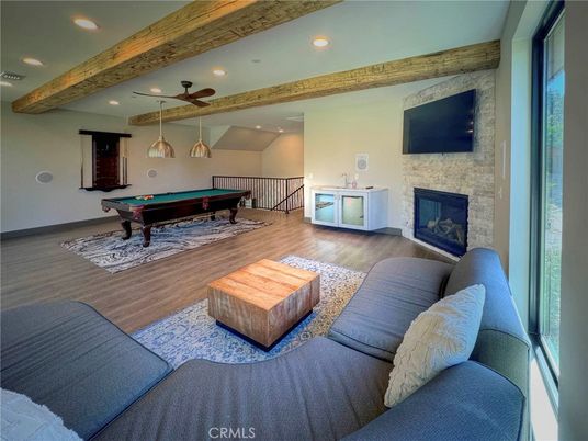 Billiard Table, Fireplace, Game Room, Interior, Living room, Pendant Lights, Recessed Lighting, Stone Walls, Wooden Beams, Wood Texture Flooring