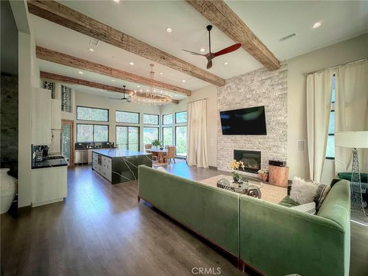 Chandelier, Dining room, Fireplace, Interior, Living room, Pendant Lights, Recessed Lighting, Stone Walls, Wooden Beams, Wood Texture Flooring