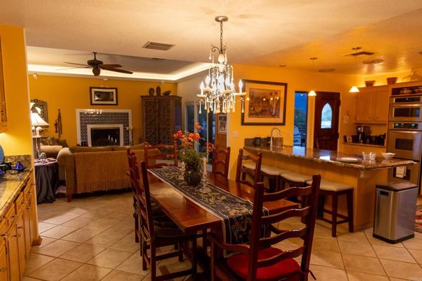 Chandelier, Dining room, Fireplace, Interior, Kitchen, Living room, Pendant Lights, Stainless Steel Appliances